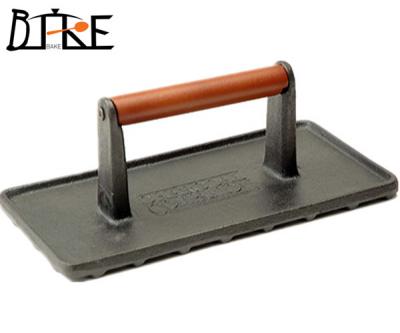 Cast iron grill press with wooden handle ()