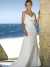 Beach wedding gown features in satin and drapes in a modified silhouette ()